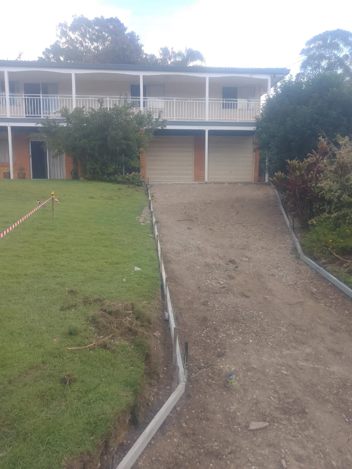 Before: Dirt track to a driveway you can push a pram up