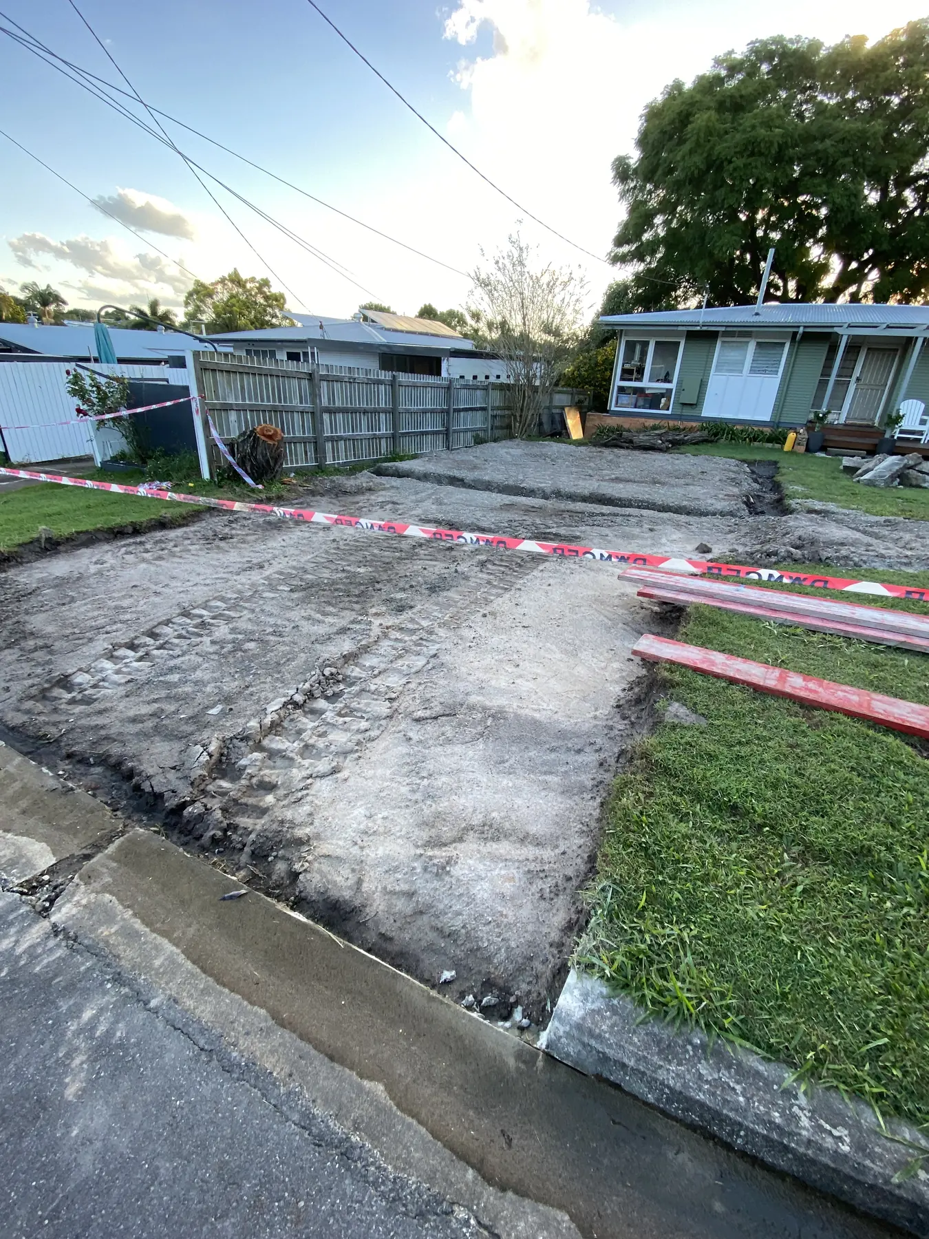 Before: Torn-up front yard to a wide new driveway