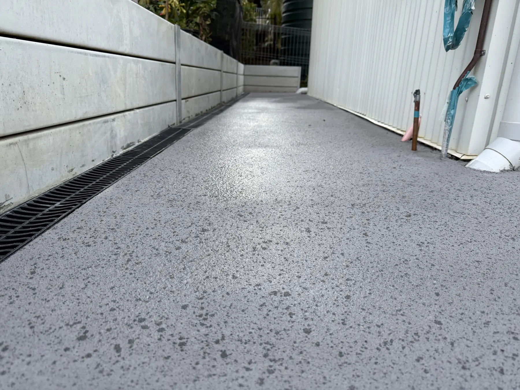 Exposed aggregate side path with a strip drain