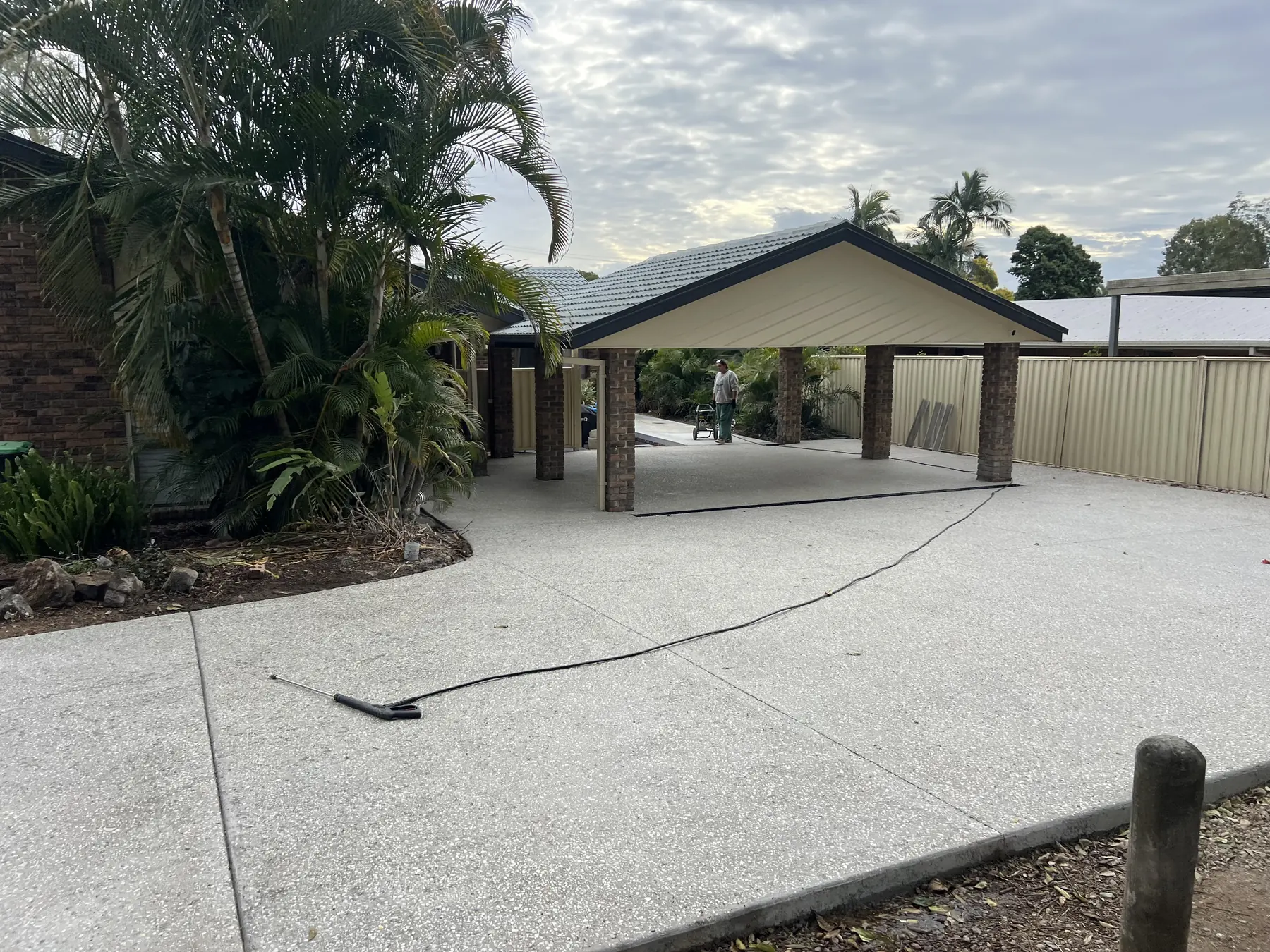 Exposed aggregate carport apron with fresh landscaping